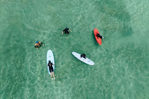 Aerial view of family having surf lesson