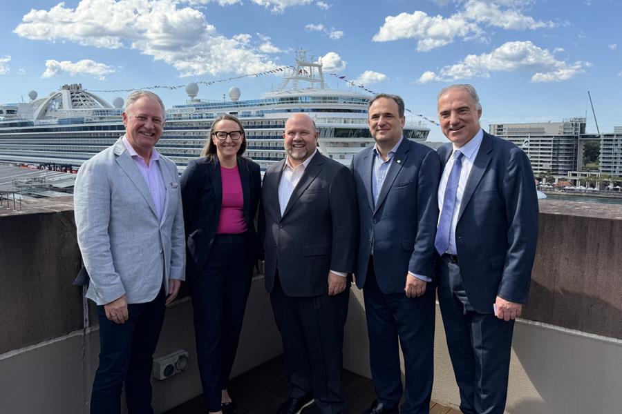 Executives with cruise ship as backdrop