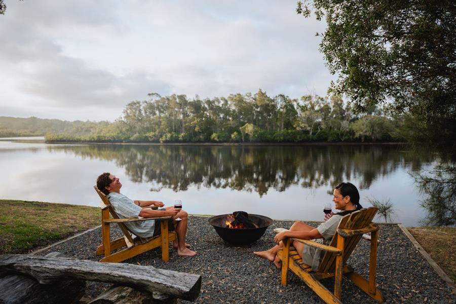 Couple sitting on the banks of the Myall River