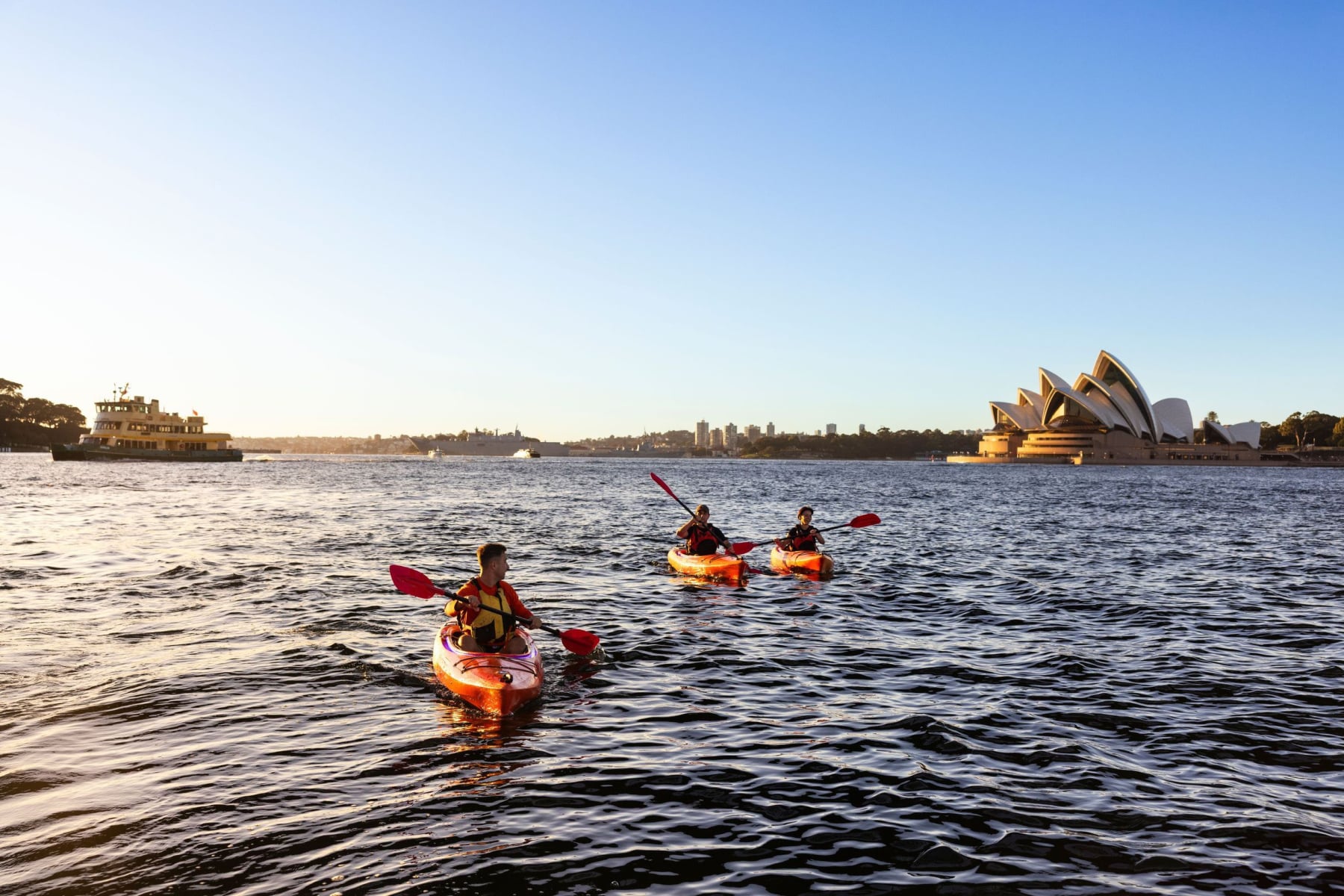 Three people kayaking in Sydney Harbour